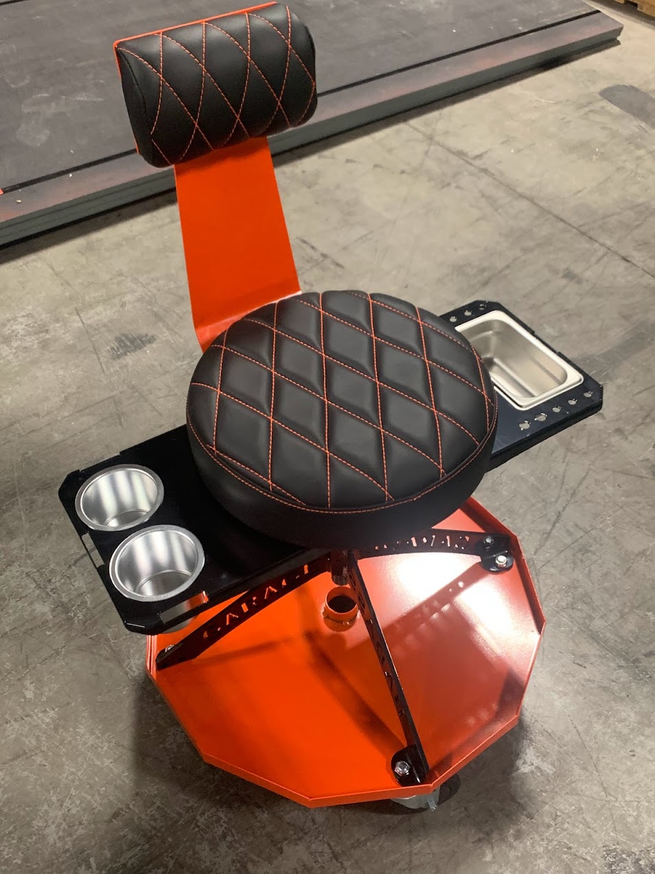 https://badass-workbench.com/wp-content/uploads/2021/05/Garage-Stool-orange-with-cup-holder-and-solid-tray-2.jpg